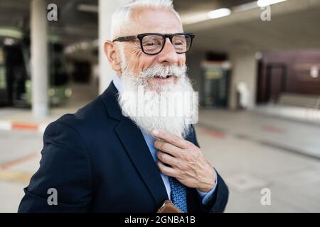 Senior hipster business man waiting at bus station - Focus on face Stock Photo
