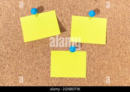 Group of Yellow sticky notes on a cork board for adding text. Template Mock up Stock Photo