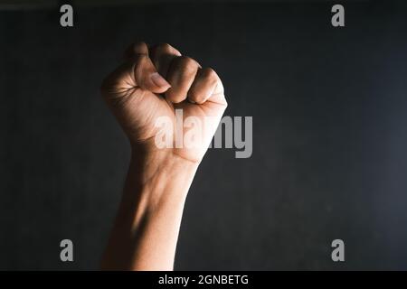 hands clenched power strength isolated on black , Stock Photo