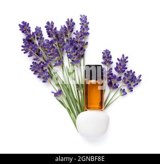 Bottle of lavender essential oil on white stone and fresh lavender flowers isolated over white background. Composition. Flat lay Stock Photo