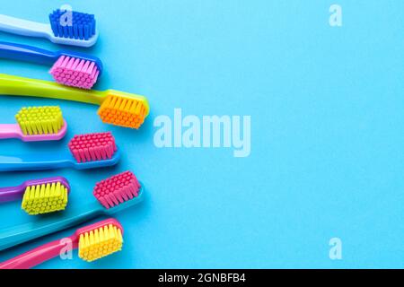 Colorful Toothbrushes On Blue Paper Background Stock Photo - Alamy