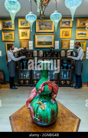 London, UK. 24 Sep 2021. A Burmantofts Faience Green-Glazed Double Gourd Vase, 1885, NO.676, Estimate GBP 2,000 - GBP 3,000 with other items - An Aesthetic Odyssey - The Peter Rose and Albert Gallichan Collection, at Christies King Street, London. It will be offered for sale in a live auction on 30 September 2021. The couple were pioneering collectors of 19th Century fine and decorative arts and this collection was assembled over the course of a lifetime from the 1950s onwards. Ensuring that the scholarly legacy of their life's work lives on, the proceeds from the sale - which is expected to Stock Photo