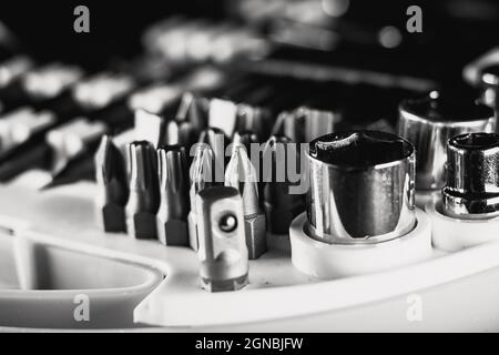 Selective focus shot of a new set of screwdrivers, bits, and socket heads in a toolbox Stock Photo