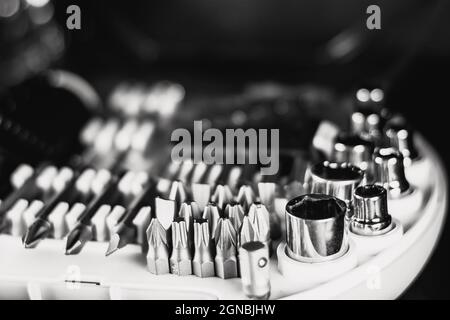 Selective focus shot of a new set of screwdrivers, bits, and socket heads in a toolbox Stock Photo