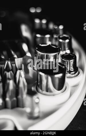 Selective focus shot of a new set of screwdrivers bits and socket heads in a toolbox Stock Photo