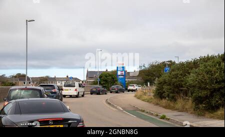 Camborne, Cornwall, 24th September 2021, People panic buying Fuel queue in their cars outside Tesco, Camborne in Cornwall, there is fuel still available. In other parts of the country panic buying has encouraged some petrol stations to increase their prices.The Government has been trying to reassure people not to panic buy. Credit: Keith Larby/Alamy Live News Stock Photo