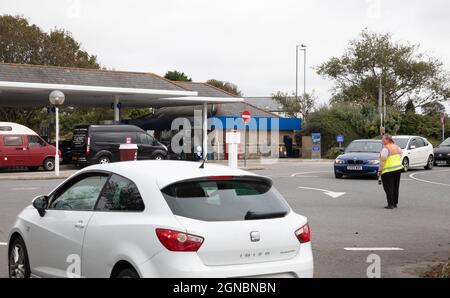 Camborne, Cornwall, 24th September 2021, People panic buying Fuel queue in their cars outside Tesco, Camborne in Cornwall, there is fuel still available. In other parts of the country panic buying has encouraged some petrol stations to increase their prices.The Government has been trying to reassure people not to panic buy. Credit: Keith Larby/Alamy Live News Stock Photo