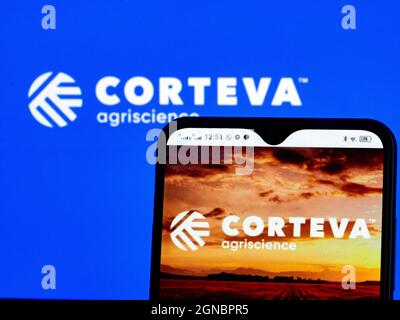 In this photo illustration, Corteva, Inc. logo seen displayed on a smartphone and in the background. Stock Photo