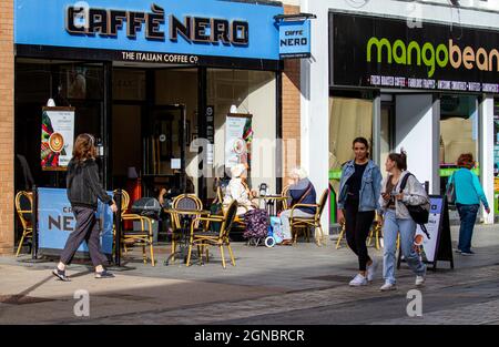 Dundee, Tayside, Scotland, UK. 24th Sep, 2021. UK Weather: Warm sunshine with fresh westerly winds across North East Scotland, temperatures reaching 19°C. Local residents spending some time out enjoying the warm sunny weather outside the Italian Caffè Nero café having refreshments in Dundee city centre. Credit: Dundee Photographics/Alamy Live News Stock Photo