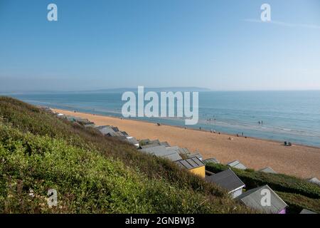 looking down across the tops of the beach huts to the beach at Milford On Sea Hampshire England Stock Photo