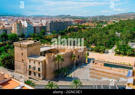 an aerial view of the Altamira Castle in Elche, Spain, and the famous Palmeral, known as Palm Grove of Elche in English, a public park with many palm Stock Photo