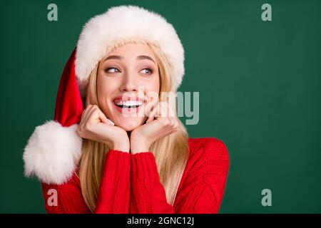 Portrait of attractive cheerful glad dreamy blond girl good mood eve winter copy space isolated over green color background Stock Photo