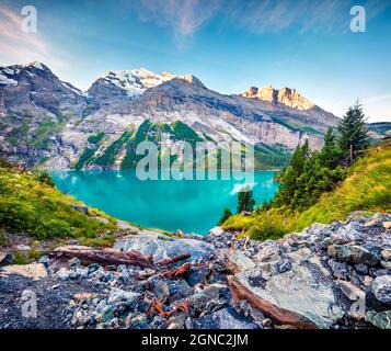Picturesque summer view of unique Oeschinensee Lake. Splendid morning scene in the Swiss Alps with Bluemlisalp mountain, Kandersteg village location, Stock Photo