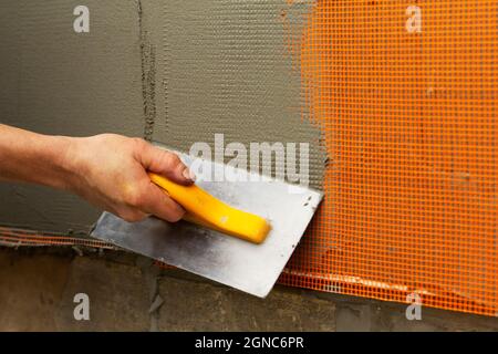 The worker performs the reinforcement and filling of the walls. Stock Photo