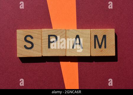 Spam, word in wooden alphabet letters isolated on background as banner headline with copy space Stock Photo