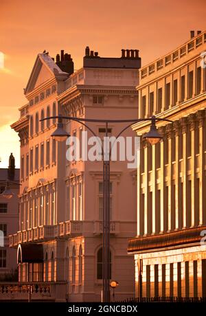 Brunswick Terrace and the bottom of Adelaide Crescent, Regency houses in Hove on Brighton and Hove seafront, illuminated by the setting sun. East Sussex, England, UK Stock Photo