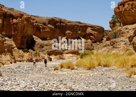 Hikers in Sesriem Canyon in Namib-Naukluft-Park, Namib desert, Maltahöhe District, Hardap Region, Namibia Stock Photo