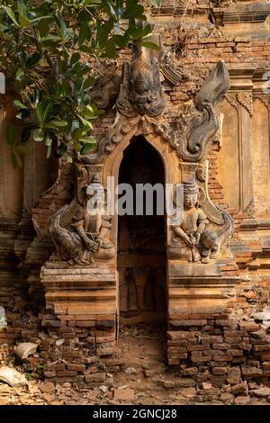 Buddhist figures and reliefs in one of the ancient red brick stupas and pagodas, in Nyaung Ohak, Shwe Indein Pagoda, Shan State, Myanmar Stock Photo