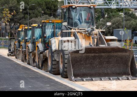 Tractors, bulldozers standing in a row. standing heavy construction wheeled bulldozer close up. Stock Photo