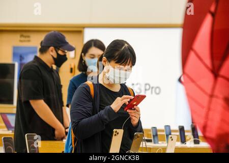 Taipei, Taiwan. 24th Sep, 2021. People are seen trying the iPhone 13 series on the launch day at the Apple store in Taipei 101. (Photo by Walid Berrazeg/SOPA Images/Sipa USA) Credit: Sipa USA/Alamy Live News Stock Photo