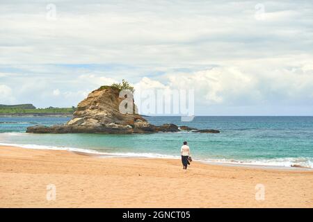Lonely woman walking on the beach, Santander, Cantabria, Spain, Europe Stock Photo