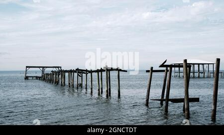 Broken pier pilings reaching into Mobile Bay from Daphne in South Alabama on the East Bay side. Stock Photo