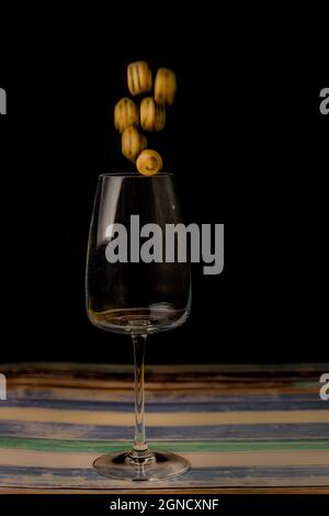 Transparent dirty glass with color dice on color wooden table Stock Photo