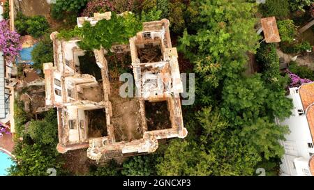 in and outside a destroyed red brick villa on Prinkipo Island, Büyükada in the Sea of Marmara near Istanbul, Turkey Stock Photo