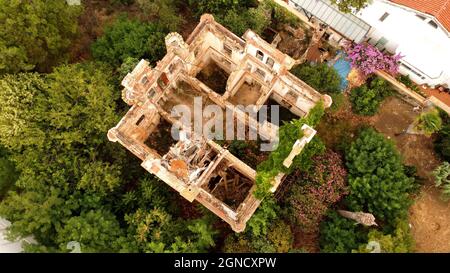 in and outside a destroyed red brick villa on Prinkipo Island, Büyükada in the Sea of Marmara near Istanbul, Turkey Stock Photo