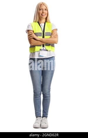 Full length portrait of a young female wearing a reflective vest and posing with crossed arms isolated on white background Stock Photo