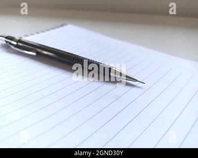 Black pen on a blank sheet of paper for taking notes Stock Photo