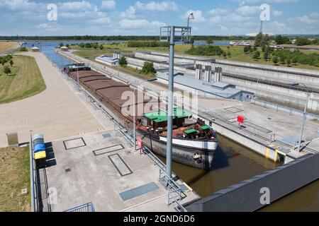 Sluice near German Magdeburg with cargo ship in lock chamber Stock Photo