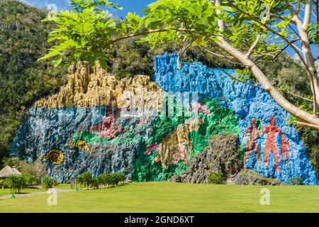 Mural de la Prehistoria The Mural of Prehistory painted on a cliff face in the Vinales valley, Cuba. Stock Photo