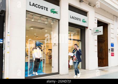A man walks past the clothing store in Valencia Stock - Alamy