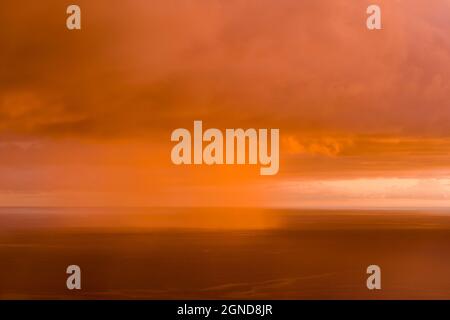 Sunset  with rain cloud over South Kona coast, Hawaii Island Stock Photo