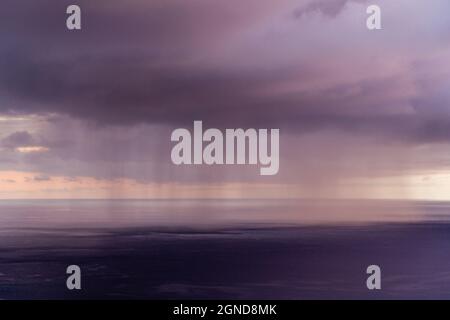 Rain cloud at sunset over Kealakekua Bay, Kona Hawaii Stock Photo