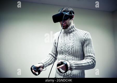 man in a helmet virtual reality plays a game Stock Photo