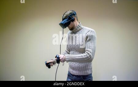 man in a helmet virtual reality plays a game Stock Photo