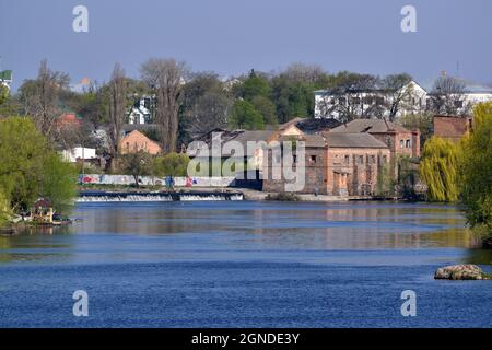 Old stone water dam across the river in the city Stock Photo