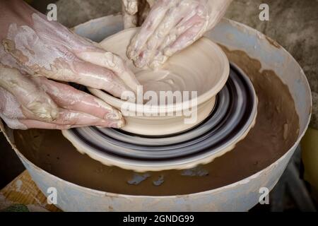 Master class on modeling of clay on a potter's wheel Stock Photo