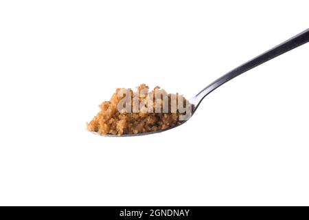 palm sugar on a spoon, golden brown color unrefined sugar product also called kithul sugar, sweet and sugary traditional food in sri lanka Stock Photo