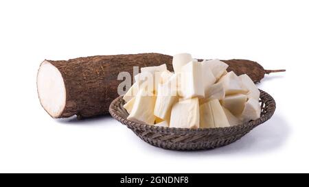 cassava or manihot, also known as manioc, yuca or brazillian arrowroot, root vegetable cut into pieces ready for cooking with a half cut root, on whit Stock Photo