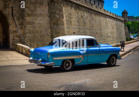 Havana, Cuba, July 2019, close up of a blue Chevrolet driving pass the police headquarters in the old city Stock Photo