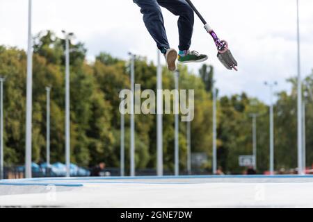 child going airborne with his scooter Stock Photo