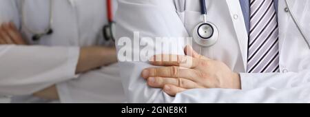 Doctors with stethoscopes around their necks are standing with arms crossed closeup Stock Photo
