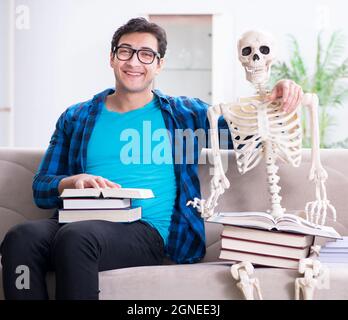 The student studying with skeleton preparing for exams Stock Photo
