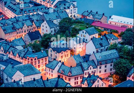 From the bird's eye view of Alesund port town on the west coast of Norway, at the entrance to the Geirangerfjord. Colorful summer evening in the Nord. Stock Photo