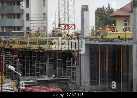 Bucharest, Romania - September 23, 2021: Construction workers on a construction site in Bucharest. Stock Photo
