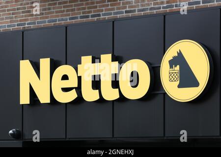 Horsens, Denmark - May 13, 2021: Netto sign on a wall. Netto is a Danish discount supermarket operating in several European countries Stock Photo