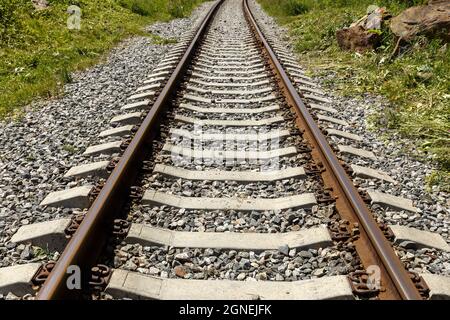 Railroad in the mountains. Railroad tracks and concrete sleepers. Stock Photo